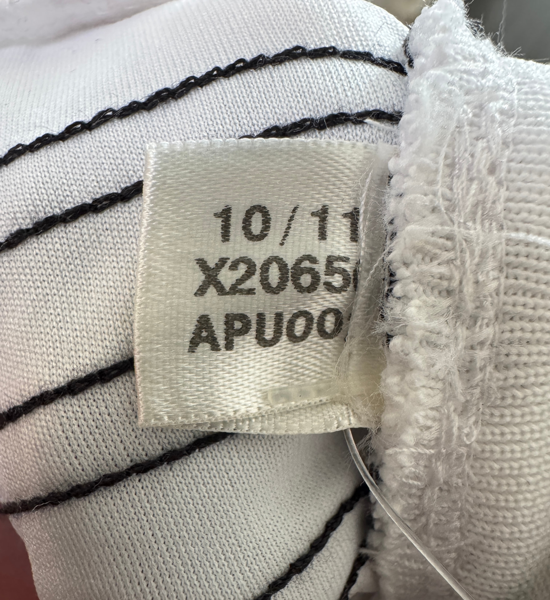 adidas shirt showing the care label inside the collar and lower left hem