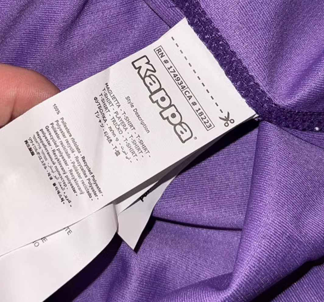 Kappa shirt with a small holographic serial label sewn inside the hem